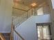View of the staircase with white spindles and wood banister leading to the second floor at 16017 Woodcote Dr, Huntersville, NC 28078