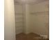 Bright walk-in closet featuring adjustable wire shelving for customized storage solutions and organization at 16017 Woodcote Dr, Huntersville, NC 28078