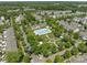 Community aerial view showcasing a pool, clubhouse, manicured lawns, and residences amid mature trees at 16610 Amberside E Rd, Cornelius, NC 28031