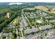 Aerial view of a residential neighborhood, showing mature landscaping, a community pool, pond and parking at 16610 Amberside E Rd, Cornelius, NC 28031