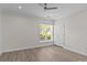 Bright bedroom features light hardwood floors, a ceiling fan, and a window with natural light at 16610 Amberside E Rd, Cornelius, NC 28031