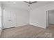 Bright, expansive bedroom boasts light hardwood floors, a ceiling fan, and neutral paint at 16610 Amberside E Rd, Cornelius, NC 28031