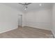 This airy bedroom features light hardwood floors, neutral paint, and stylish wall trim at 16610 Amberside E Rd, Cornelius, NC 28031