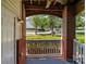Charming covered front porch with brick columns and a white railing overlooking the neighborhood at 16610 Amberside E Rd, Cornelius, NC 28031