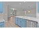 Bright kitchen with quartz counters, light blue cabinets and stainless steel appliances, perfect for modern cooking and entertaining at 16610 Amberside E Rd, Cornelius, NC 28031