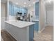 Open kitchen featuring a center island, stainless appliances and modern, eye-catching light blue cabinetry at 16610 Amberside E Rd, Cornelius, NC 28031