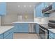 Stylish kitchen with quartz countertops, stainless steel appliances and eye catching cabinets create a perfect culinary space at 16610 Amberside E Rd, Cornelius, NC 28031