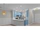 Modern kitchen with stainless steel appliances, blue cabinets and stylish lighting, ready for gourmet meals at 16610 Amberside E Rd, Cornelius, NC 28031