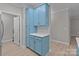 Charming kitchen area boasting stylish blue cabinets, modern hardware, and convenient access to a laundry area at 16610 Amberside E Rd, Cornelius, NC 28031