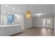 Bright living space with island bar, modern light fixture, and sliding glass doors for a serene atmosphere at 16610 Amberside E Rd, Cornelius, NC 28031