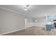 Open-concept living space with new wood-look floors, modern lighting, and a kitchen with stainless appliances at 16610 Amberside E Rd, Cornelius, NC 28031