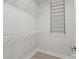 Walk-in closet featuring white wire shelving and new wood-look floors at 16610 Amberside E Rd, Cornelius, NC 28031