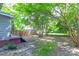 Lush backyard features mature trees, fenced perimeter, and deck at 209 W Marsh St, Salisbury, NC 28144