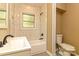 Bathroom featuring tiled shower with rainfall head, toilet, and single sink vanity at 209 W Marsh St, Salisbury, NC 28144