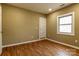 Bedroom featuring wood-look floors, neutral walls, modern lighting, and a window at 209 W Marsh St, Salisbury, NC 28144