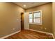Bedroom featuring wood-look floors, tan colored walls, a large window, and a doorway to a closet at 209 W Marsh St, Salisbury, NC 28144