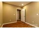 Bedroom featuring wood-look floors, tan colored walls, and a doorway to another room at 209 W Marsh St, Salisbury, NC 28144
