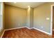 Bedroom showcasing modern lighting, wood-look floors, neutral walls, and a doorway to another room at 209 W Marsh St, Salisbury, NC 28144