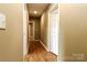 Hallway showcasing neutral colored walls, wood-look laminate flooring, and multiple doorways at 209 W Marsh St, Salisbury, NC 28144