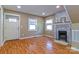 Cozy living room featuring wood floors, a brick fireplace, and natural light at 209 W Marsh St, Salisbury, NC 28144
