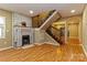 Inviting living room with a brick fireplace, wood floors, and an open staircase at 209 W Marsh St, Salisbury, NC 28144