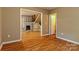 Spacious living room showcasing wood floors, fireplace, and an open doorway at 209 W Marsh St, Salisbury, NC 28144