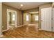 Open living room featuring wood-look floors, neutral walls, and doorways to other rooms at 209 W Marsh St, Salisbury, NC 28144