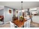 Inviting dining room adjacent to the kitchen with a wooden table, white chairs, and stylish lighting at 2315 Perry Rd, Denver, NC 28037