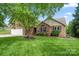 Charming brick home with a well-manicured lawn, two-car garage, and inviting front entrance at 2315 Perry Rd, Denver, NC 28037