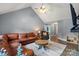 Bright living room featuring vaulted ceiling, hardwood flooring, comfortable seating, and modern décor at 2315 Perry Rd, Denver, NC 28037
