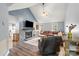 Cozy living room with stone fireplace, vaulted ceilings, wood floors, and comfortable seating at 2315 Perry Rd, Denver, NC 28037