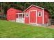 Exterior of a red shed with white trim, a small fenced enclosure, and well-maintained lawn at 2315 Perry Rd, Denver, NC 28037