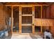 Interior of a wooden framed shed with a wire mesh door, small perch, and metal watering trough at 2315 Perry Rd, Denver, NC 28037
