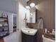 Stylish bathroom with wood paneled walls, vessel sink, modern lighting, and decor at 232 W Wilson Ave, Mooresville, NC 28115