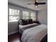 Cozy bedroom with three windows, a ceiling fan, hardwood floors, and a metal bed frame at 232 W Wilson Ave, Mooresville, NC 28115