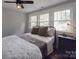 Bedroom with a ceiling fan, hardwood floors, metal frame bed and windows at 232 W Wilson Ave, Mooresville, NC 28115