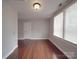 Bedroom view featuring hardwood floors, neutral paint, and natural light from the window at 232 W Wilson Ave, Mooresville, NC 28115