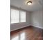 Bright bedroom featuring hardwood floors, neutral paint, and natural light from the window at 232 W Wilson Ave, Mooresville, NC 28115