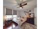 Bedroom featuring a bed, hardwood floors, fan, and natural light from the windows at 232 W Wilson Ave, Mooresville, NC 28115