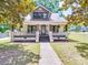 Charming two-story home features a welcoming front porch with dark trim and a walkway to the door at 232 W Wilson Ave, Mooresville, NC 28115