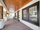 Inviting front porch with painted brick, dark trim windows, and warm wood flooring at 232 W Wilson Ave, Mooresville, NC 28115