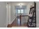 Hallway with hardwood floors, neutral paint, and a modern light fixture overhead at 232 W Wilson Ave, Mooresville, NC 28115