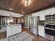 Open concept kitchen with stainless steel appliances, island, and wood ceiling at 232 W Wilson Ave, Mooresville, NC 28115