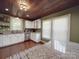 Eat-in kitchen featuring white cabinets, granite countertops, and a wood ceiling at 232 W Wilson Ave, Mooresville, NC 28115
