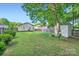 A large backyard with a shed and partial fence at 2424 Pitts Dr, Charlotte, NC 28216