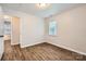 A bright bedroom with modern flooring and a view into another room at 2424 Pitts Dr, Charlotte, NC 28216
