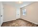Bedroom with ample closet space, wood-look floors, and a ceiling light at 2424 Pitts Dr, Charlotte, NC 28216