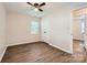Bright bedroom with ceiling fan, wood-look floors, and natural light at 2424 Pitts Dr, Charlotte, NC 28216