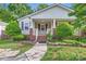 Charming single-story home with a covered front porch and well-manicured landscaping at 2424 Pitts Dr, Charlotte, NC 28216