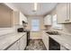 Efficient kitchen with white cabinetry, stainless steel appliances, and easy-to-clean counters at 2424 Pitts Dr, Charlotte, NC 28216